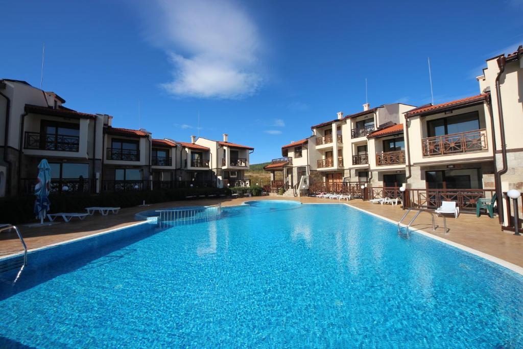 a large swimming pool in front of some buildings at Menada Imperial Heights Villas in Sunny Beach