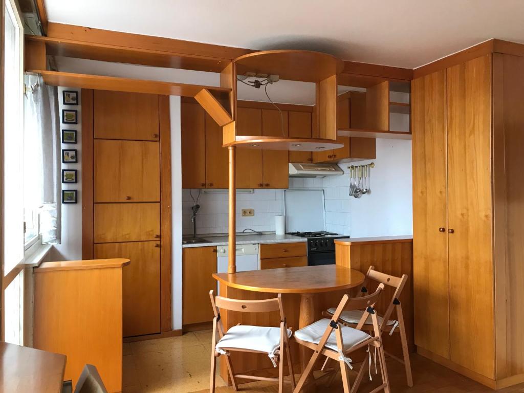 a kitchen with a table and chairs in a room at BEA Active Studio near city center Tivoli Park in Ljubljana