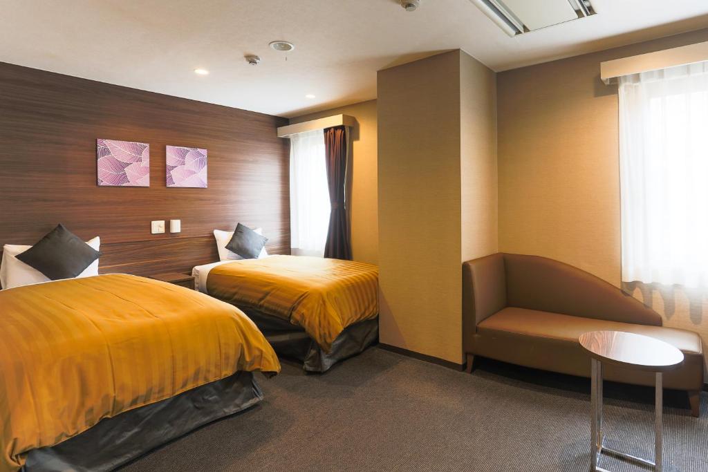 En eller flere senge i et værelse på Sun Royal Kawasaki