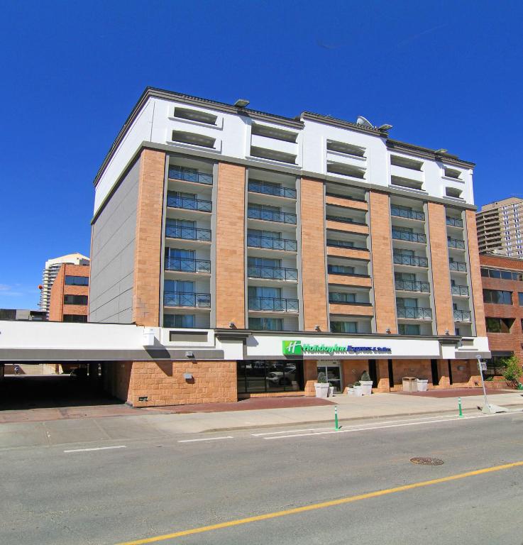 a large building on the corner of a street at Holiday Inn Express and Suites Calgary by IHG in Calgary