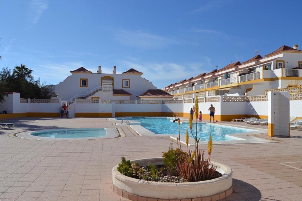 a courtyard with a swimming pool and some buildings at Sun & Sol in Caleta De Fuste