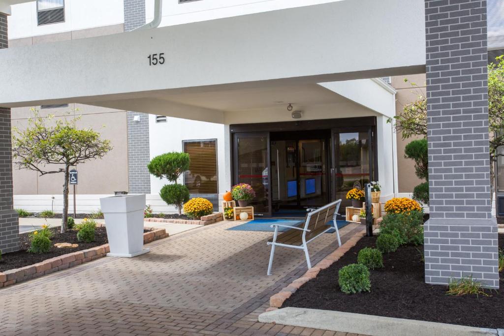 a porch with a chair in front of a building at Holiday Inn Express Wilmington, an IHG Hotel in Wilmington