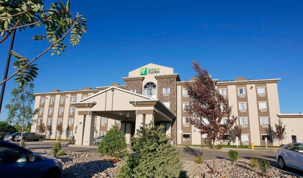 a hotel building with a car parked in front of it at Holiday Inn Express Fort St John, an IHG Hotel in Fort Saint John