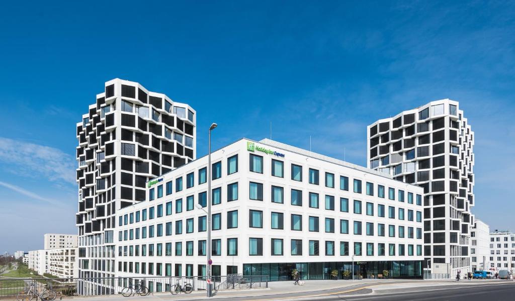 two tall white buildings in front of a street at Holiday Inn Express Munich City West, an IHG Hotel in Munich