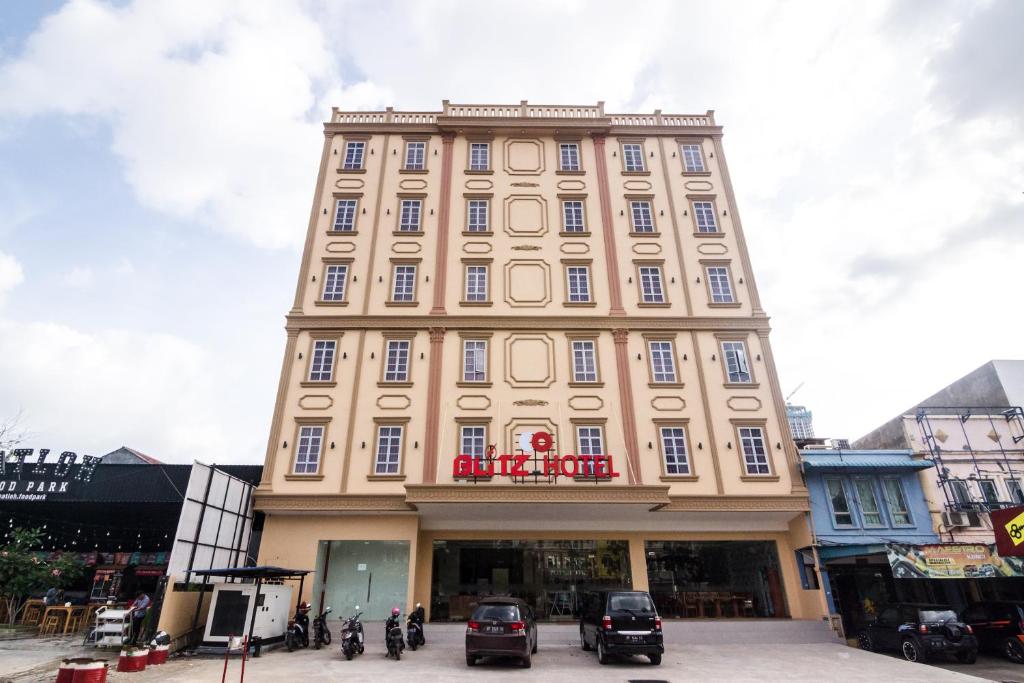 a tall building with a sign on top of it at Blitz Hotel Batam Centre in Batam Center