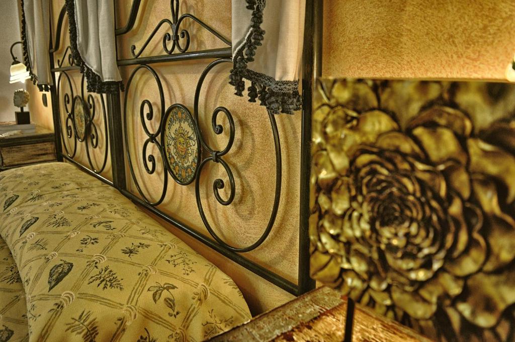 a bedroom with a bed with a wooden head board at Hotel Victoria in Taormina