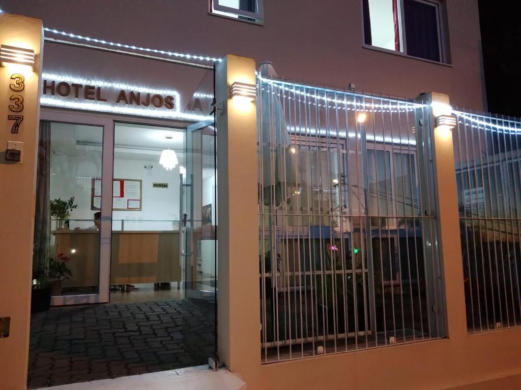 a hotel entrance with a gate in front of a building at Hotel Anjos LTDA in Gravataí