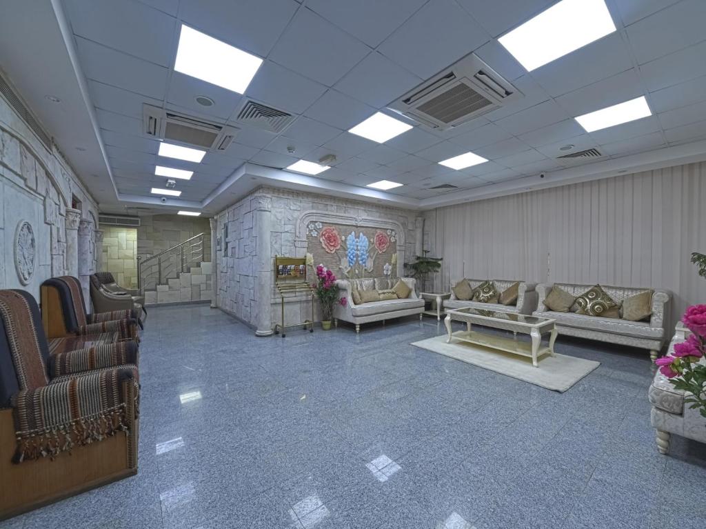 a waiting room with couches and chairs in a building at Platinium Hotel Apartments in Seeb