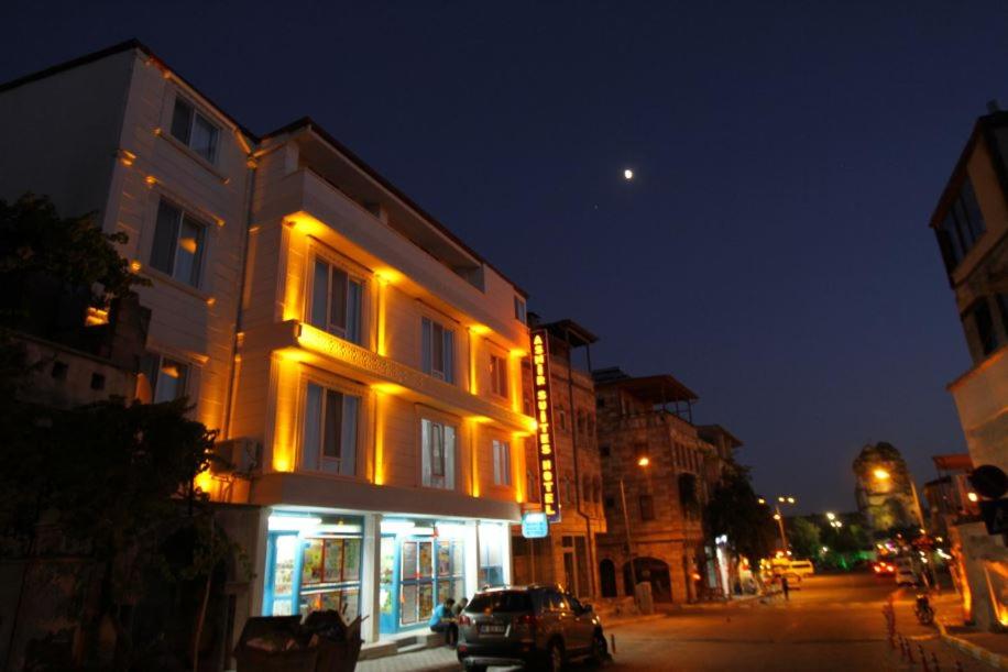 a lit up building on a city street at night at Asmir Suites Hotel in Nevsehir