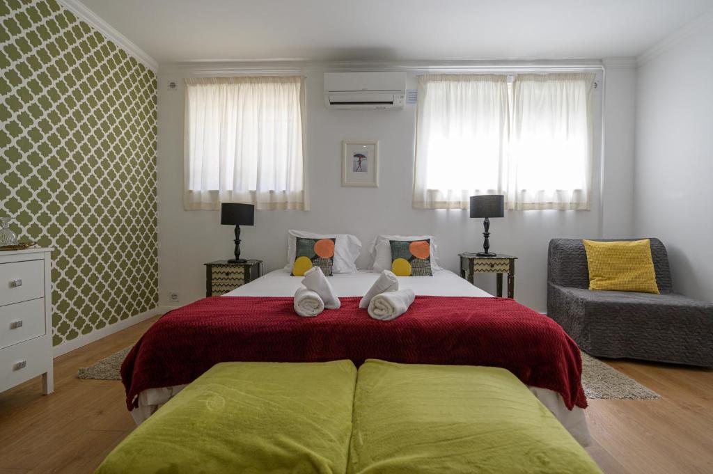 A bed or beds in a room at Casa das Hortênsias - Charming Guest House