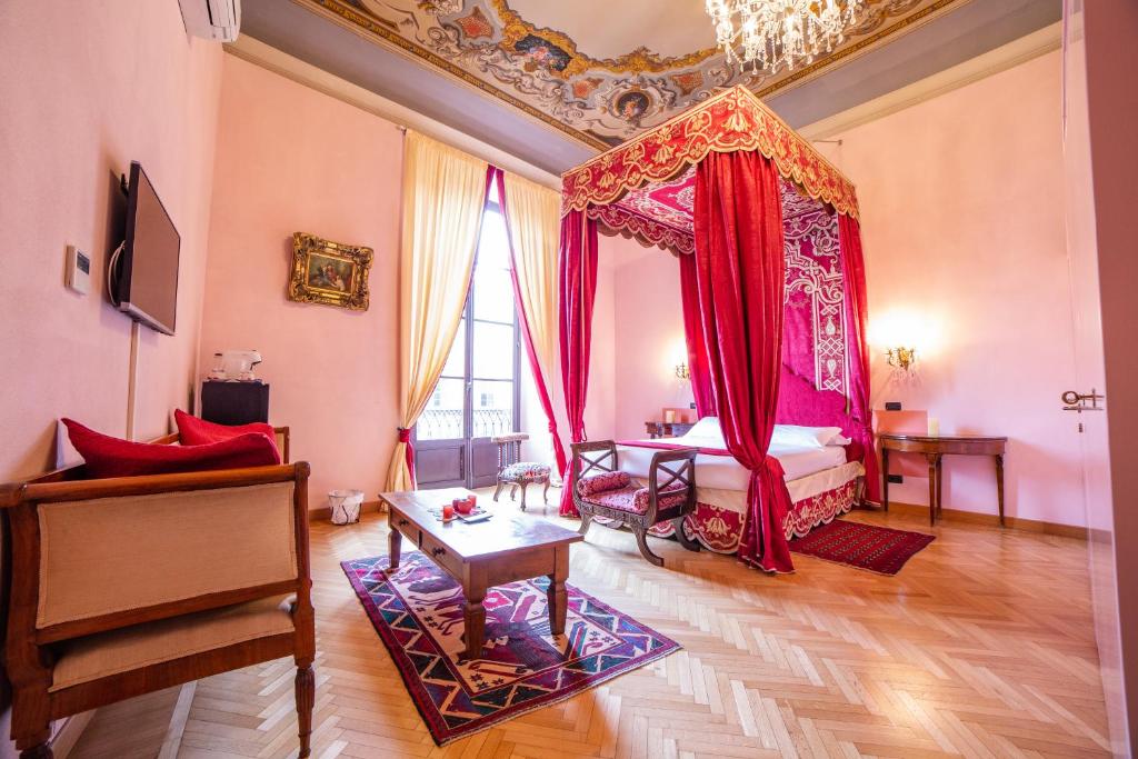 a bedroom with a bed with a red canopy at B&B Galileo 2000 in Florence