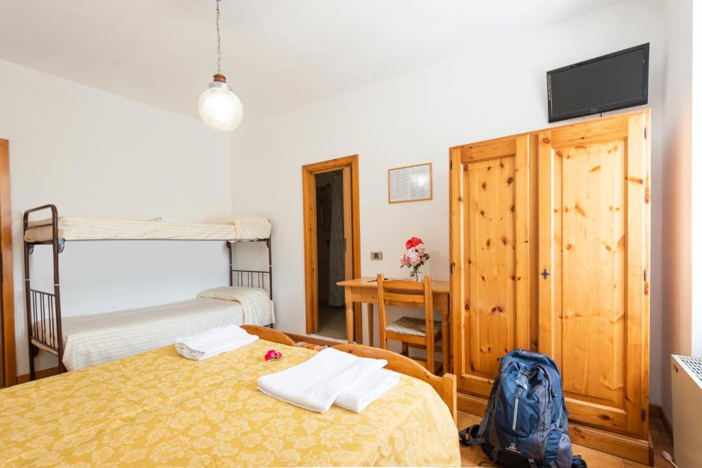 Postel nebo postele na pokoji v ubytování Rifugio Monte Baldo