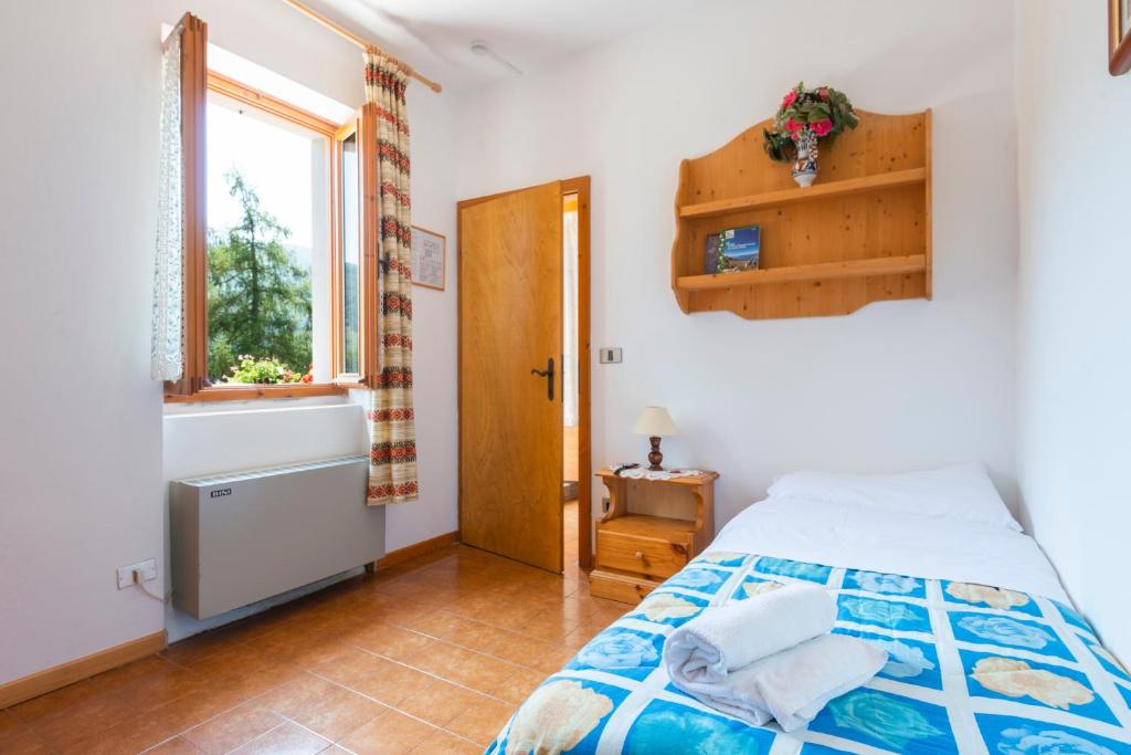 Postel nebo postele na pokoji v ubytování Rifugio Monte Baldo