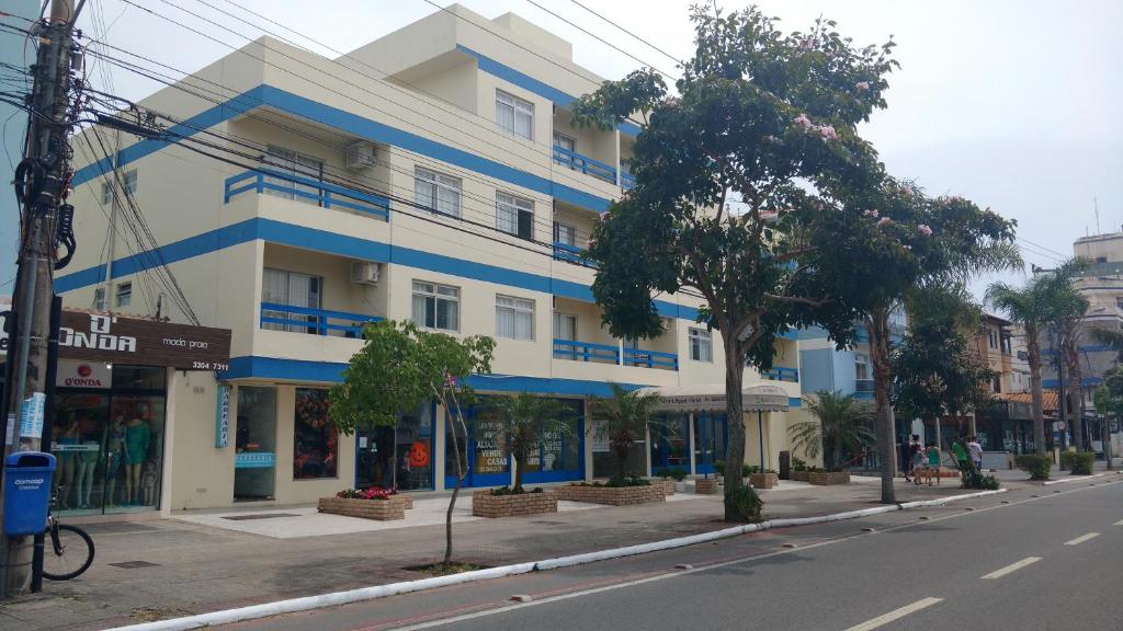 a blue and white building on the side of a street at Petit Praia Hotel in Florianópolis