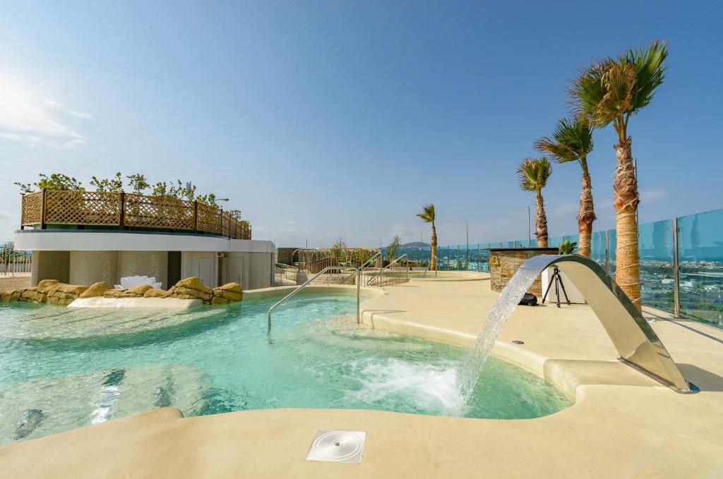 a swimming pool with a pool table and a surfboard at Luxe Holiday Rentals in Gibraltar