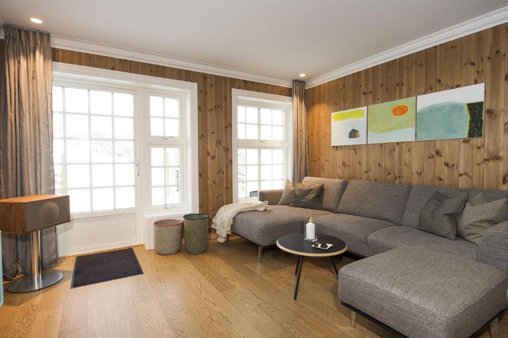 a living room with a couch and a table at Dr. Holms Hotel Leilighet in Geilo