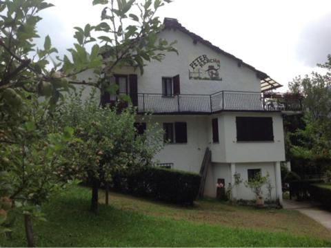 a white house with a balcony on top of it at Peter Ranch 3 in Vico Canavese