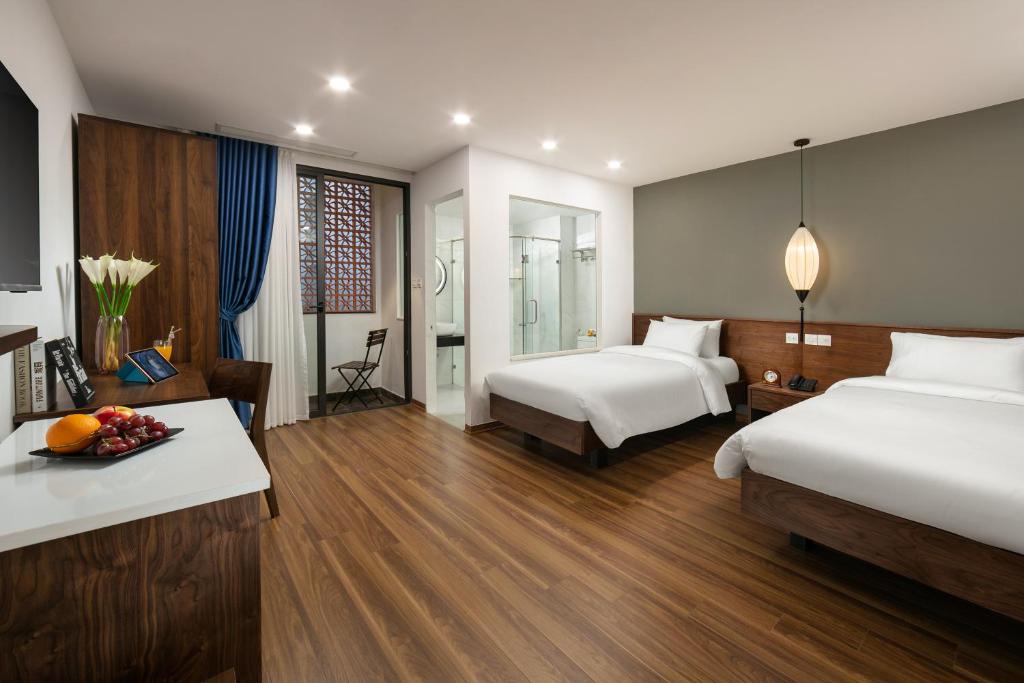 Postel nebo postele na pokoji v ubytování Hanoi Exclusive Hotel