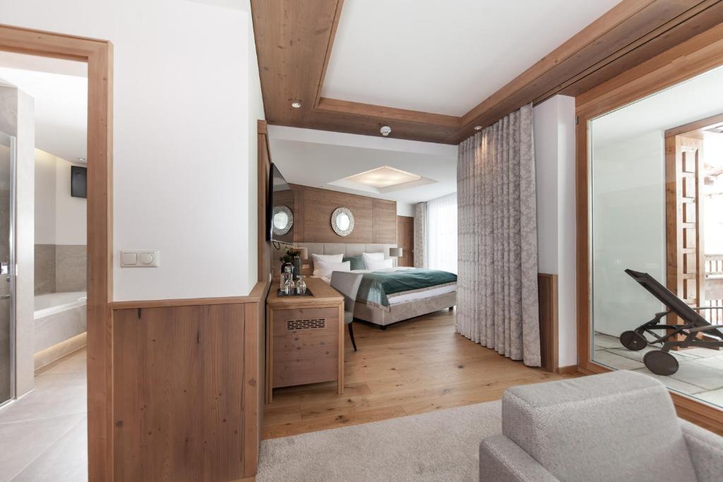 a bedroom with a bed and a couch in a room at Schlosshotel Fiss in Fiss