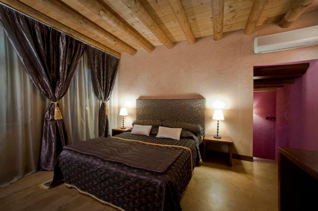 a bedroom with a bed in a room with curtains at Casa Magnani in Verona