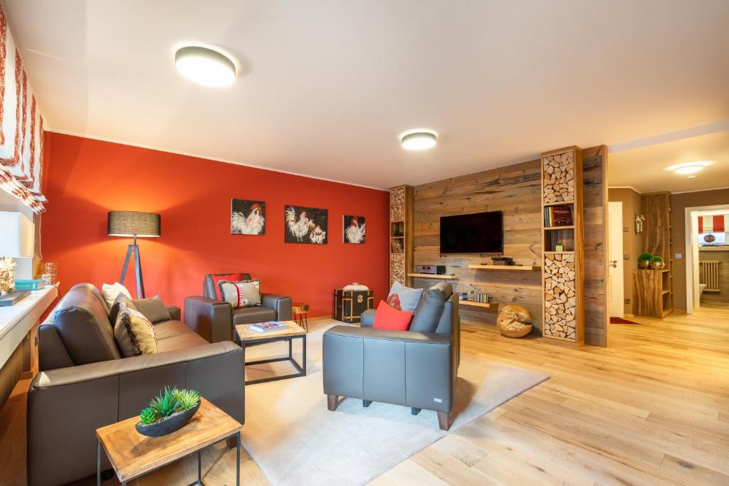 a living room with a couch and a tv at Große Wies in Oberstdorf