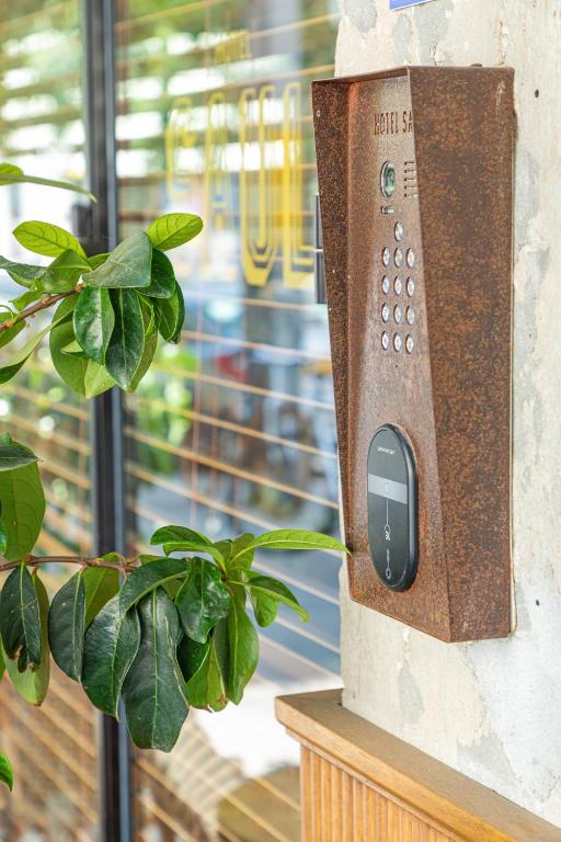 a television attached to a wall with a plant at The Saul in Tel Aviv
