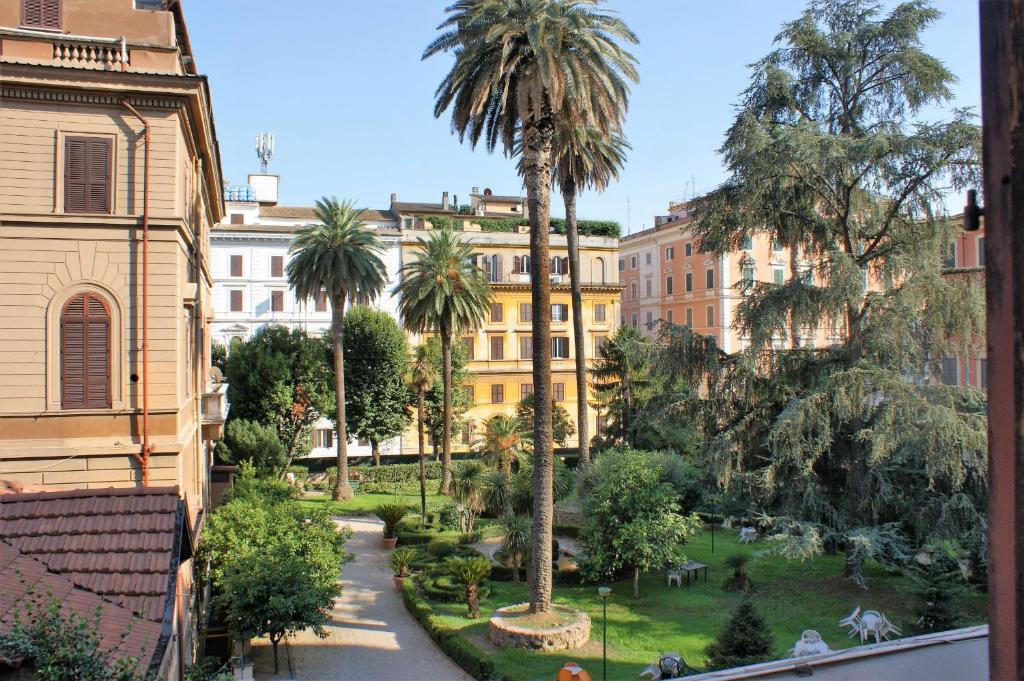 a view of a park with palm trees and buildings at Capitolium Rooms in Rome
