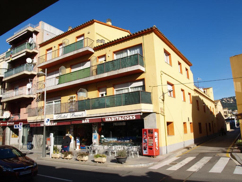 a building on the corner of a city street at Hostal Barnes in Santa Cristina d'Aro