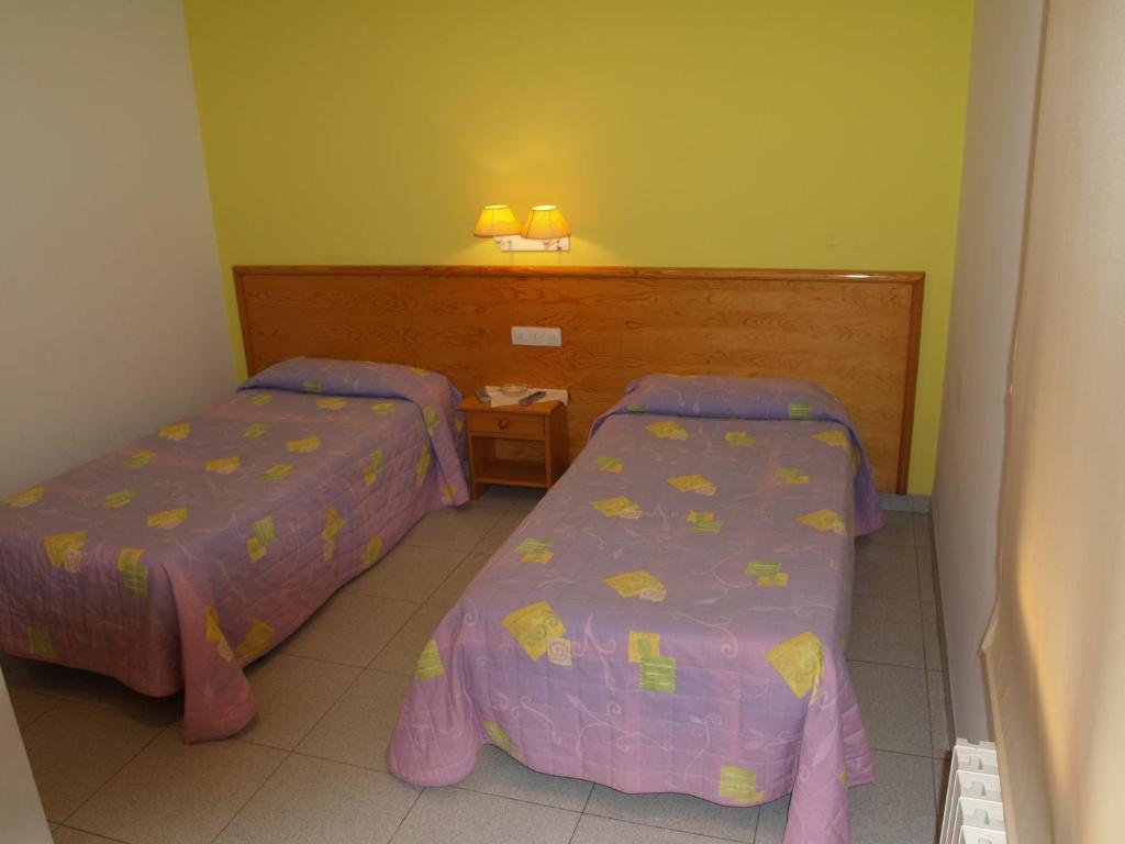 Postel nebo postele na pokoji v ubytování Hostal Barnes