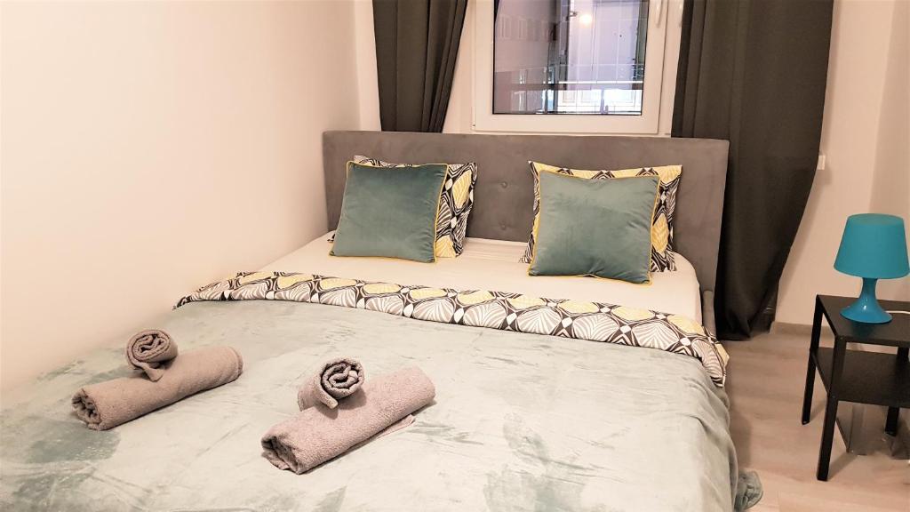 a bedroom with a large bed with four pillows at Centrum Warszawy - City Center the best places, metro Centrum & Świętokrzyska, partial view of the Palace of Culture, self check-in, AC, optional breakfest in Warsaw