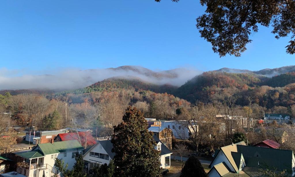 a town with a mountain in the background with clouds in the sky at Spring Creek Hotel in Hot Springs