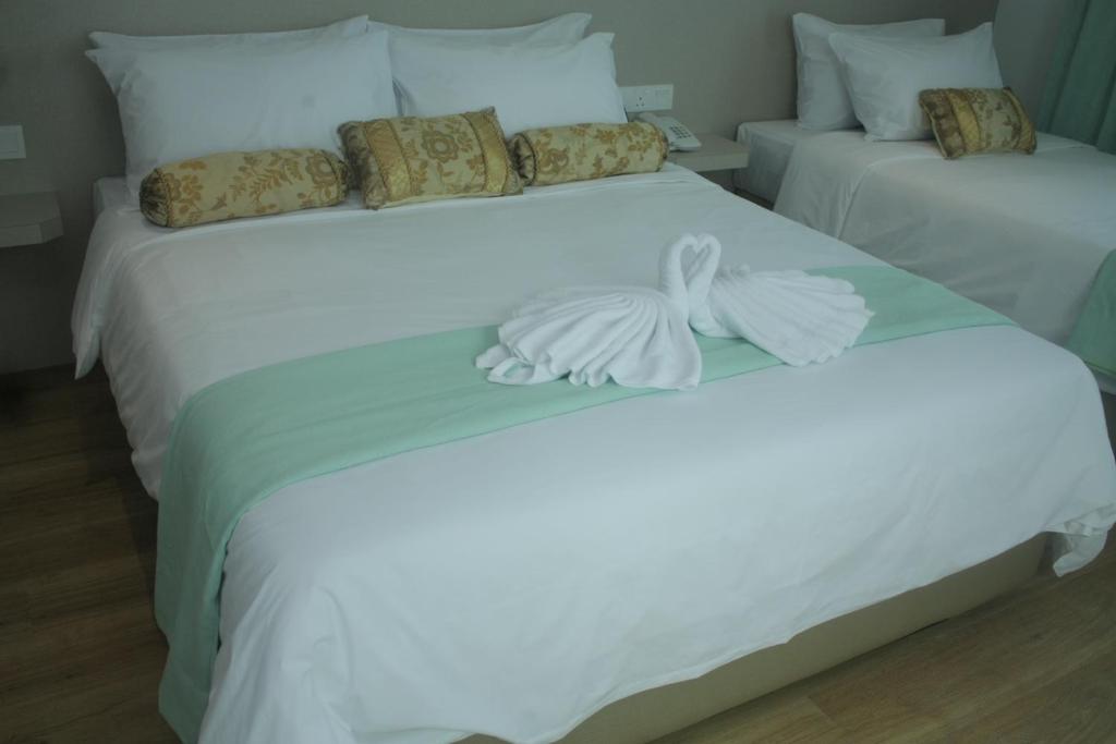 Postel nebo postele na pokoji v ubytování Citi Hotel