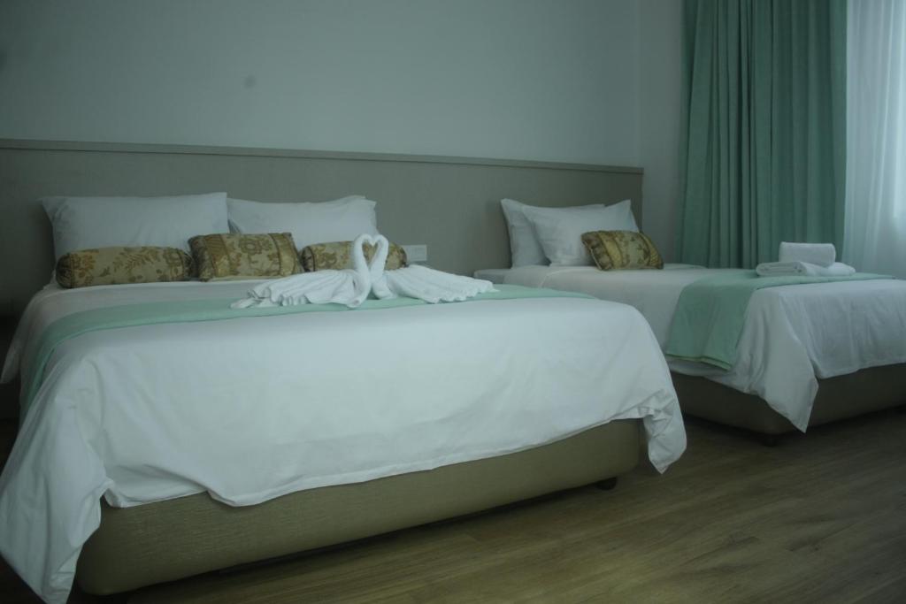 Postel nebo postele na pokoji v ubytování Citi Hotel