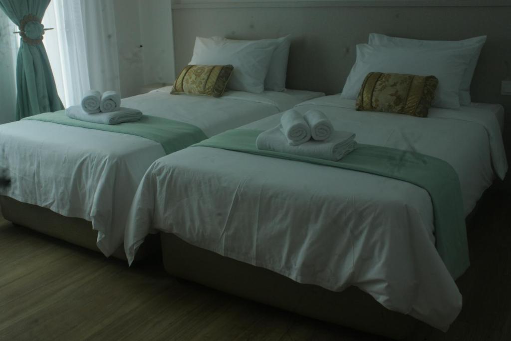 Postel nebo postele na pokoji v ubytování Citi Hotel