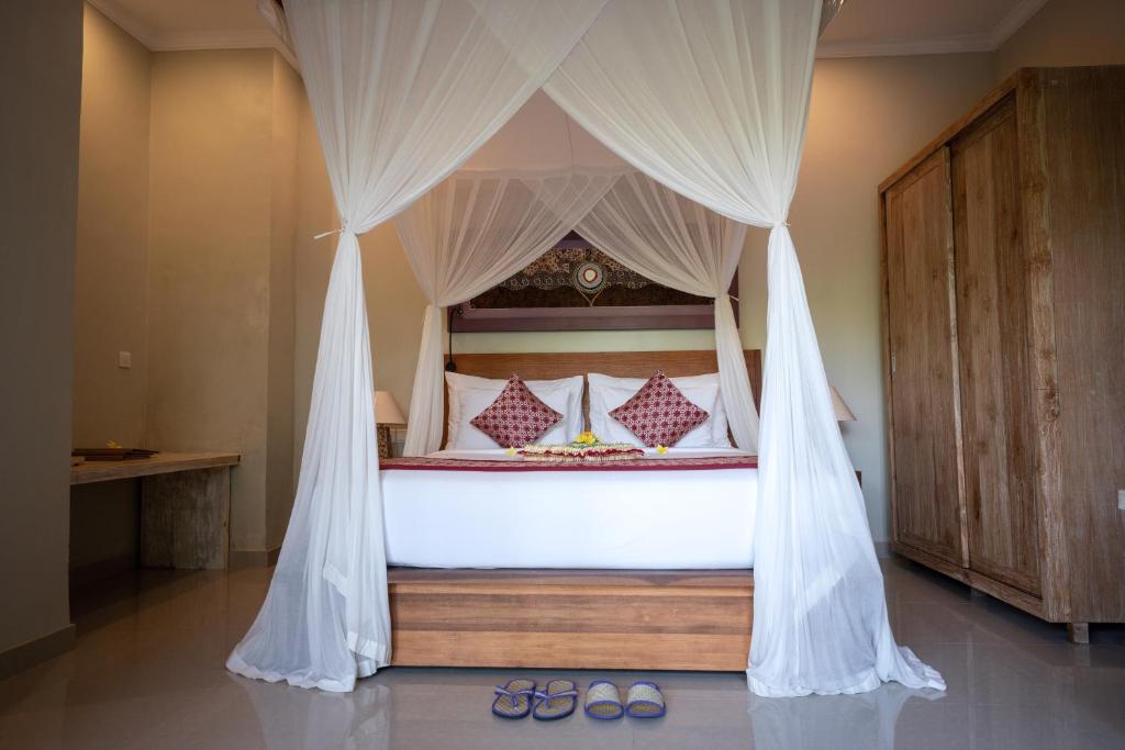 Postel nebo postele na pokoji v ubytování Nata Ubud