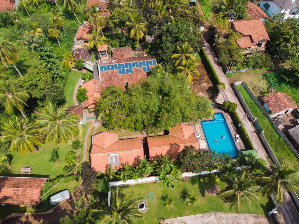 an aerial view of a house with a swimming pool and palm trees at Villa Shade in Negombo
