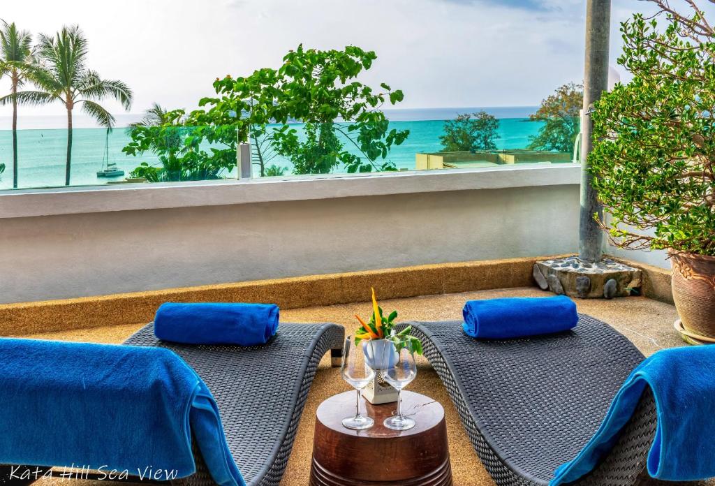 a balcony with two tables and a view of the ocean at KATA PENTHOUSE SEA VIEW private POOL in Kata Beach