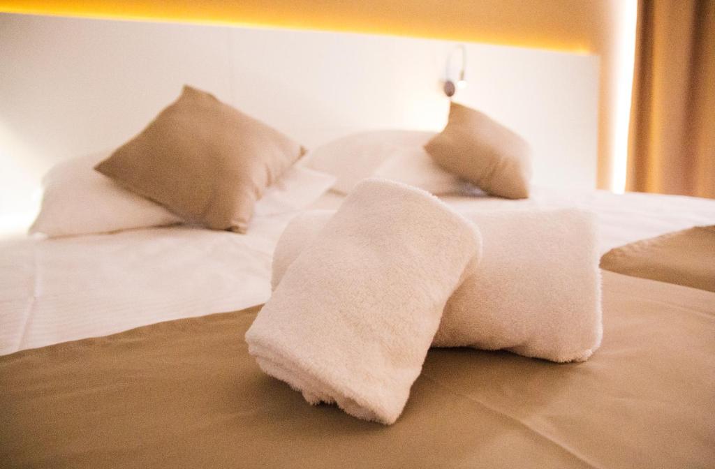 a white bed with pillows on top of it at Planet Blue Hotel in El Arenal