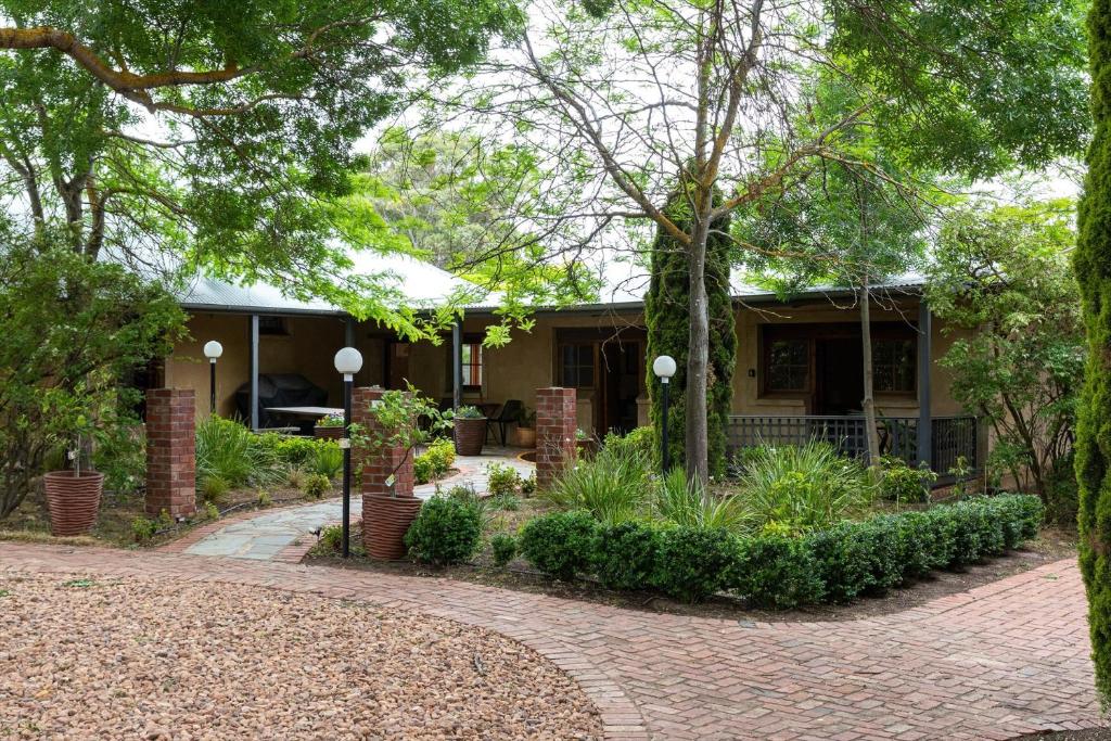 a house with a brick driveway in front of it at Kaesler Cottages in Nuriootpa