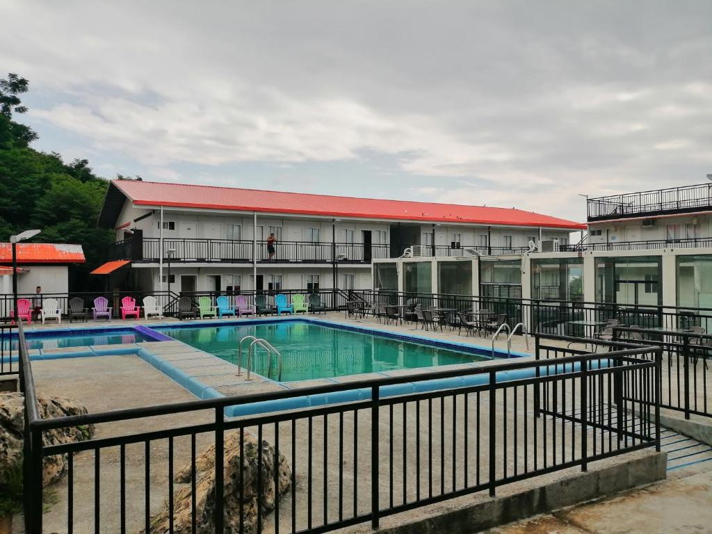 a swimming pool in front of a building at By The Sea Hotel Bulalacao in Bulalakao