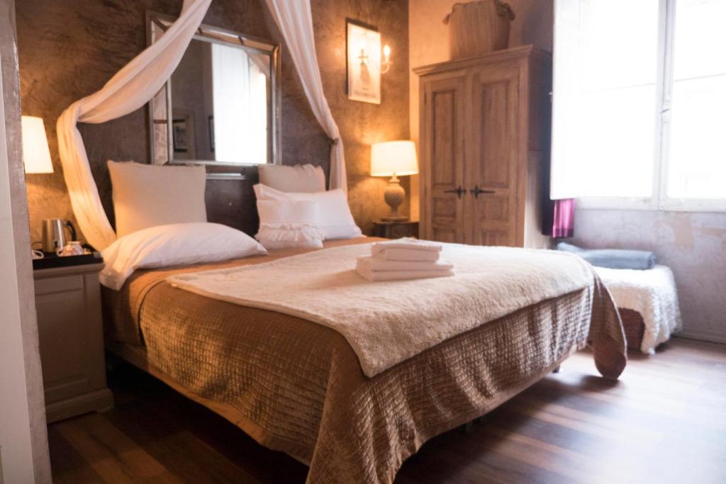 a bedroom with a bed with white sheets and a window at Les Chambres de Amelie B&B in Bologna