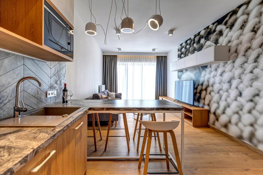 a kitchen with a table and a dining room at Cotton House in Łódź