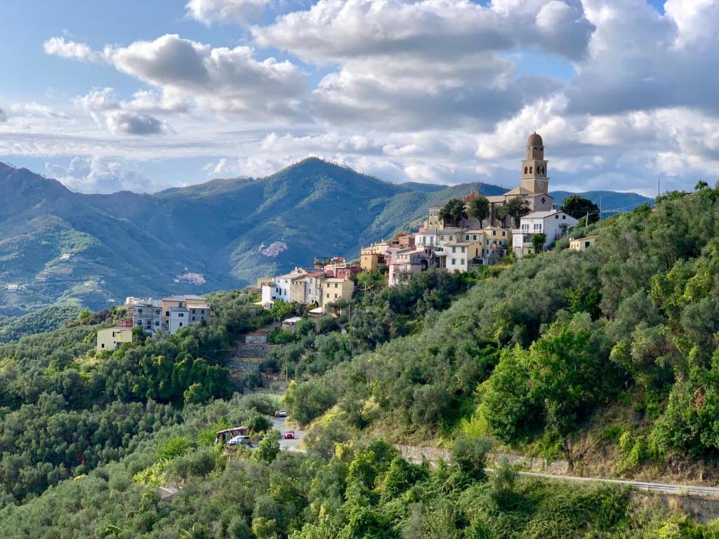 a village on a hill with mountains in the background at Agriturismo I Pipetta in Levanto