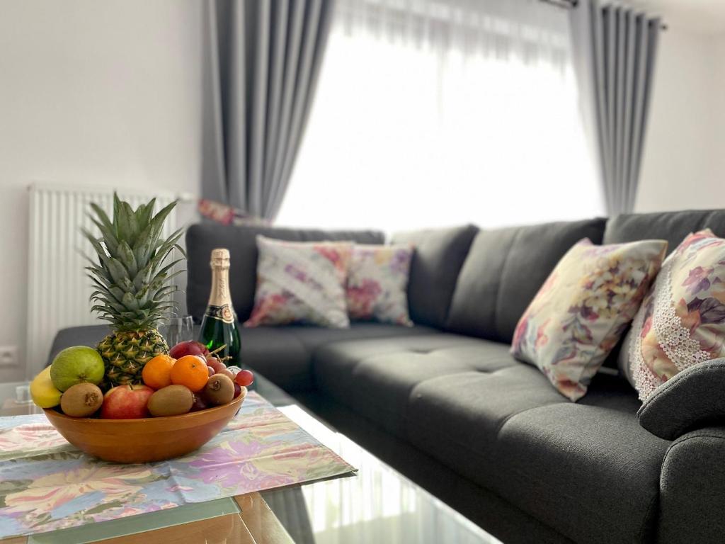 a living room with a couch and a bowl of fruit on a table at Villa Jarka Rent in Ždiar