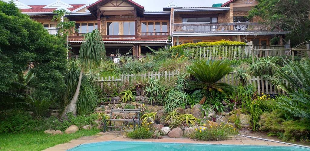 a house with a garden and a swimming pool at IRONWOOD LODGE in Pennington