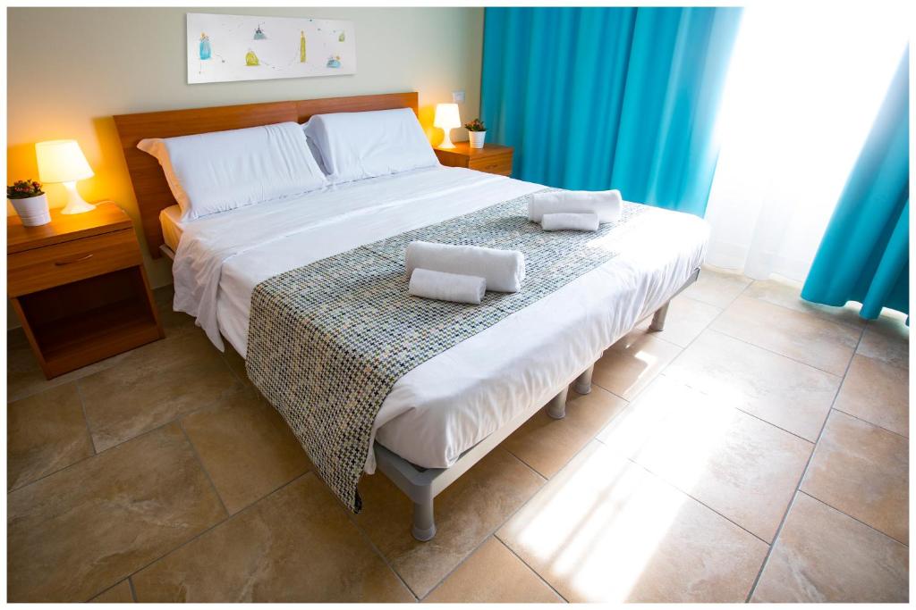 a bedroom with a large bed with two pillows on it at Santa Teresa House in Verona