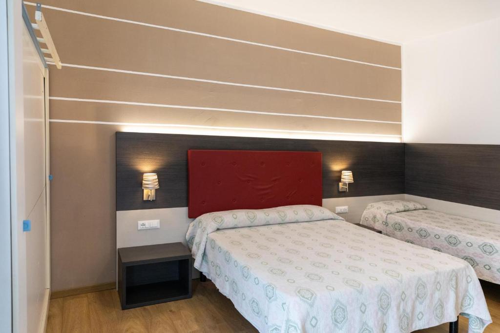 Postel nebo postele na pokoji v ubytování Hotel Verdi