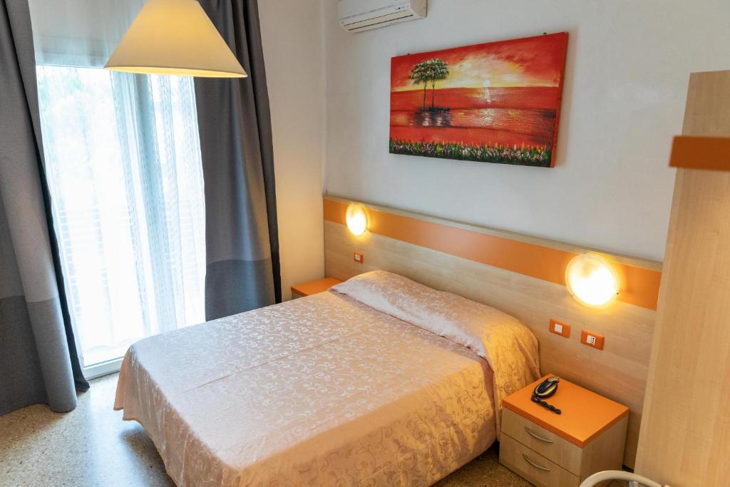 Postel nebo postele na pokoji v ubytování Hotel Verdi