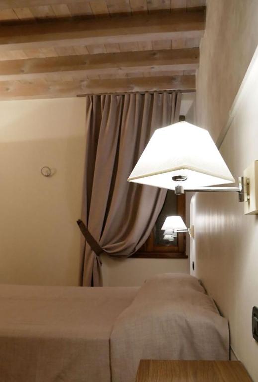 Postel nebo postele na pokoji v ubytování Hotel La Valle