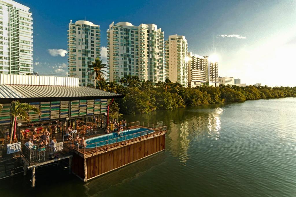a resort on a river in a city with tall buildings at Mayan Monkey Cancun in Cancún
